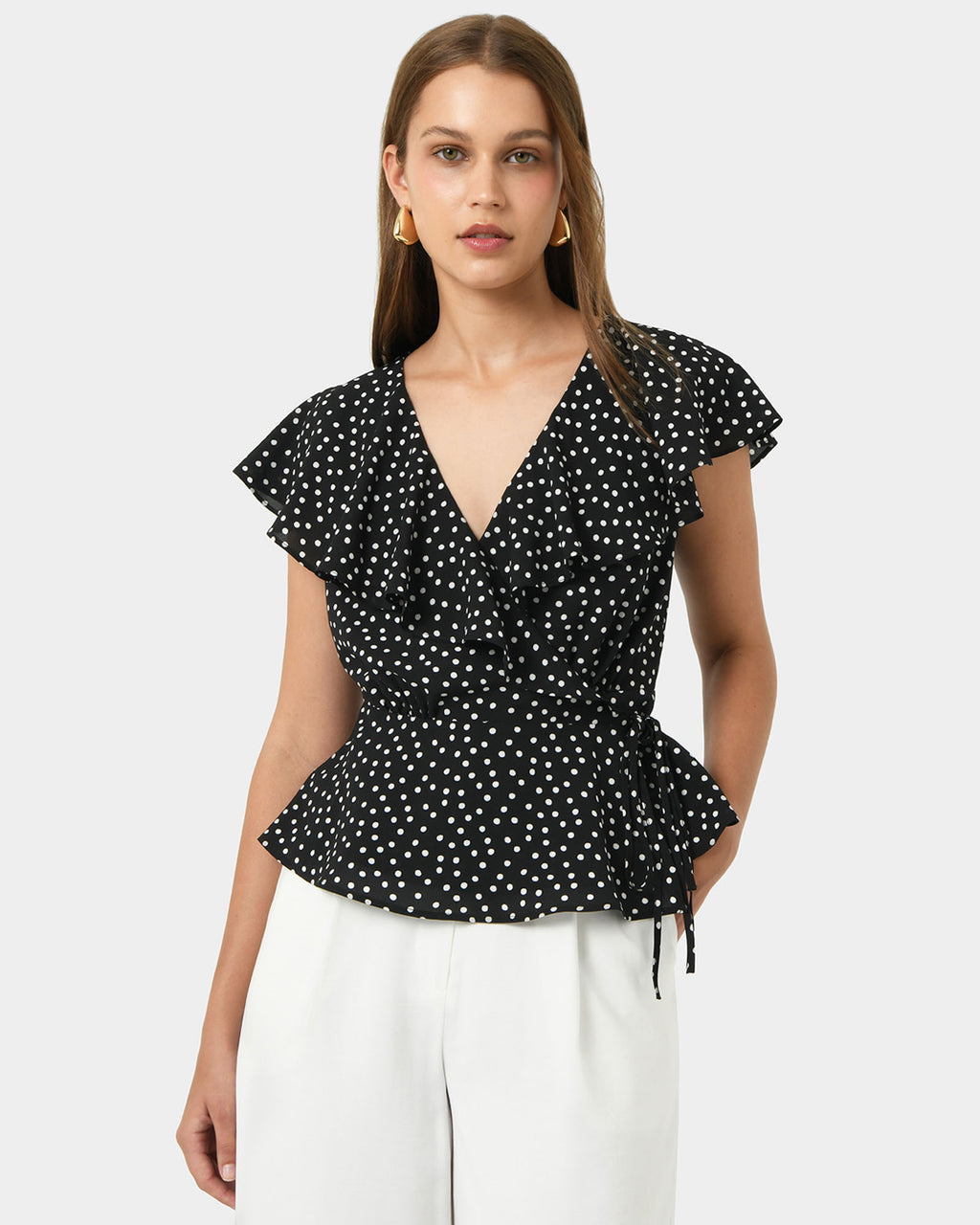 Jules Ruffle Wrap Blouse in polka dot — close-up view