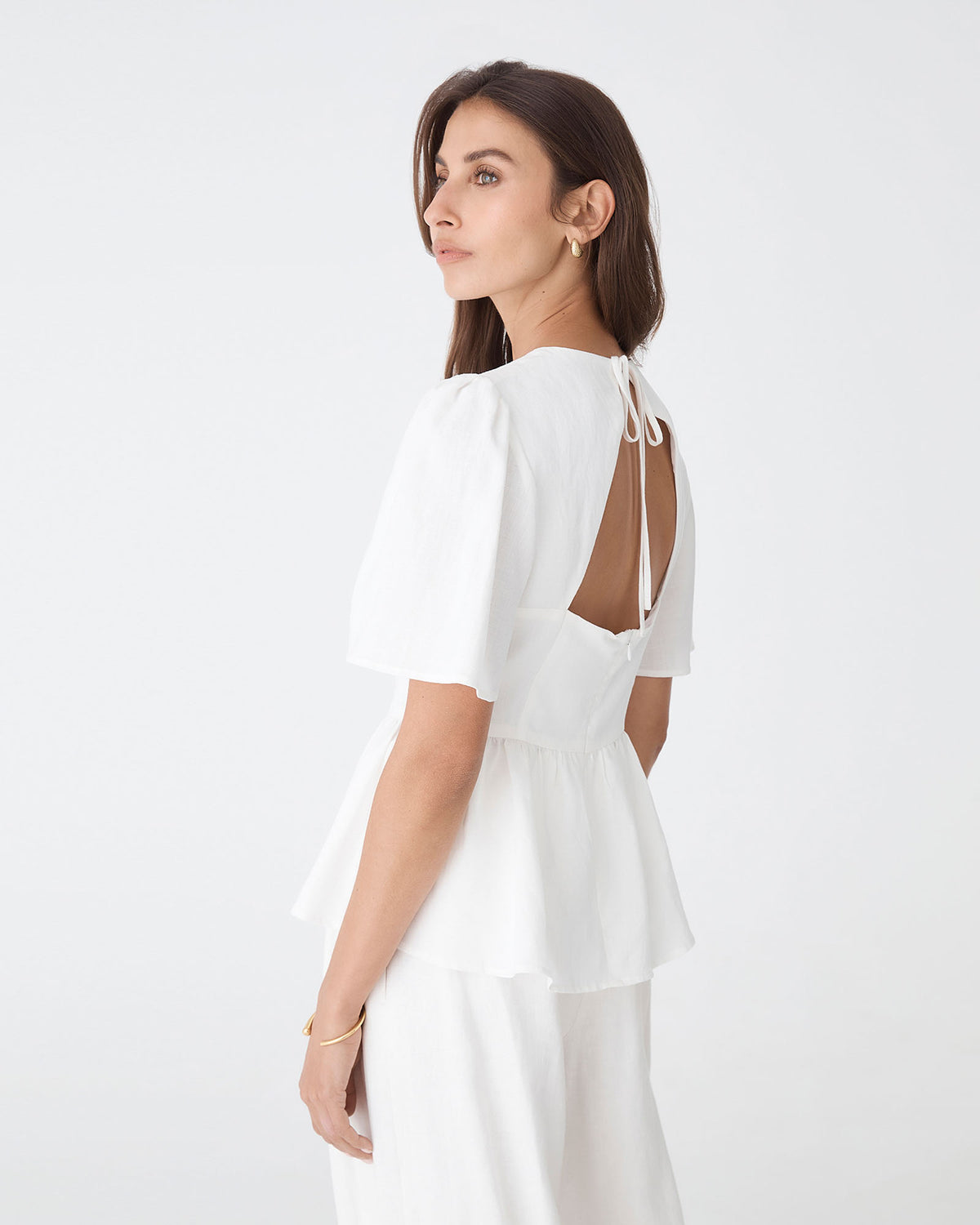 Jade Linen Peplum Top in ivory — back view