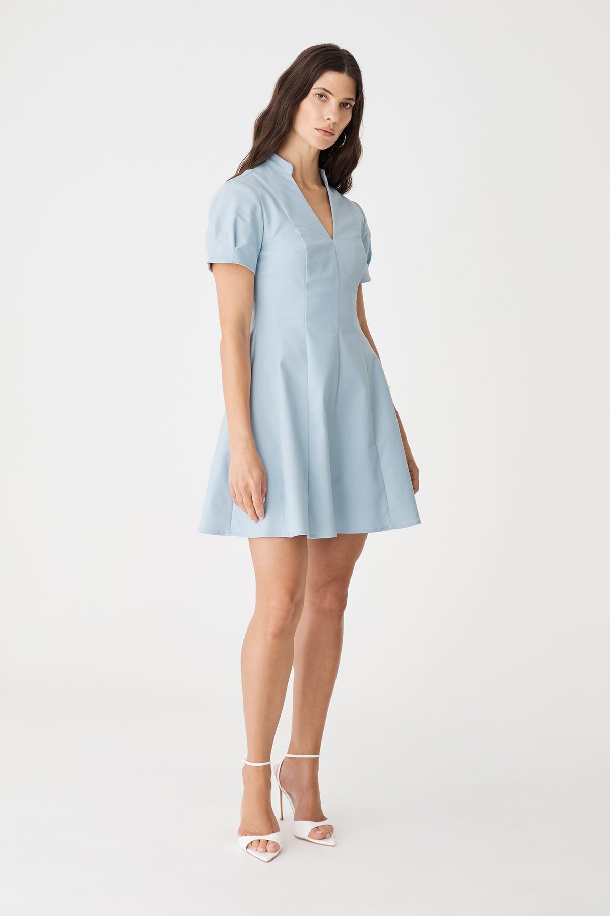 Side view showing vertical panel seams and short sleeves