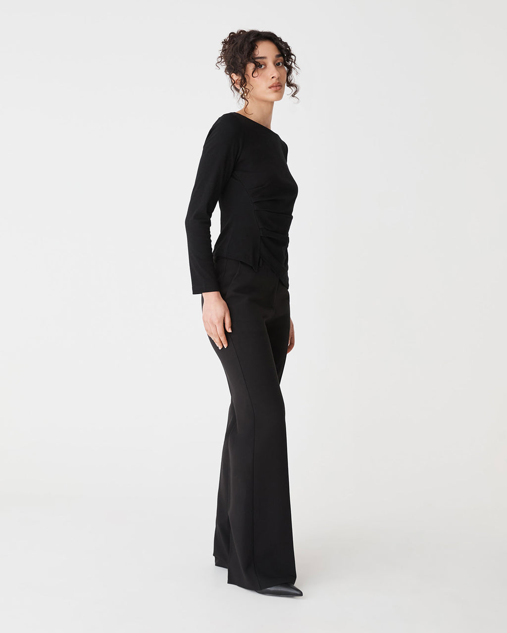 Calia Asymmetric Knit Top in black — side view